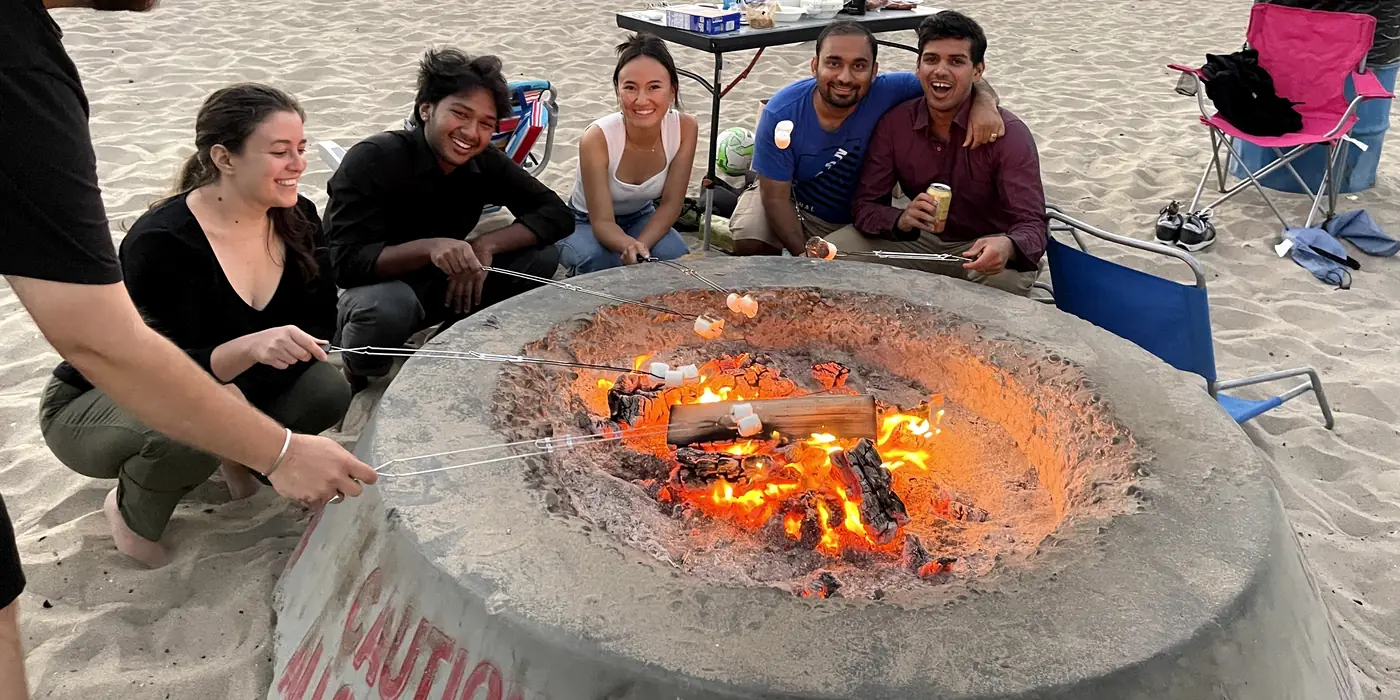 The team around a beach bonfire